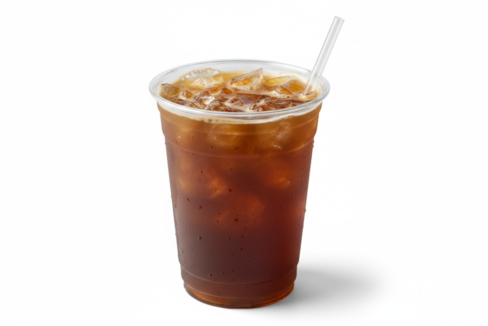 cold brew on ice in plastic sup with straw